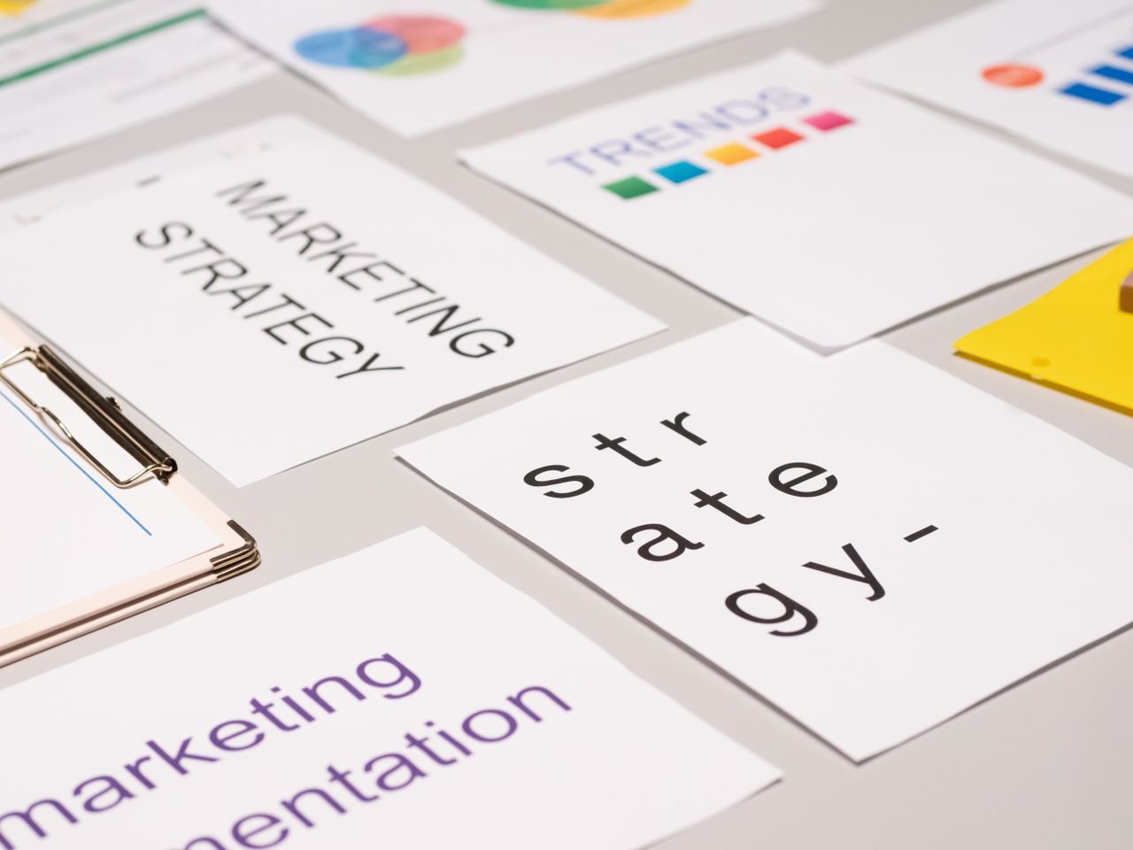 Crafting Captivating Headlines: Your awesome post title goes here A top view of marketing strategy documents and graphs arranged on a desk, showcasing business planning.