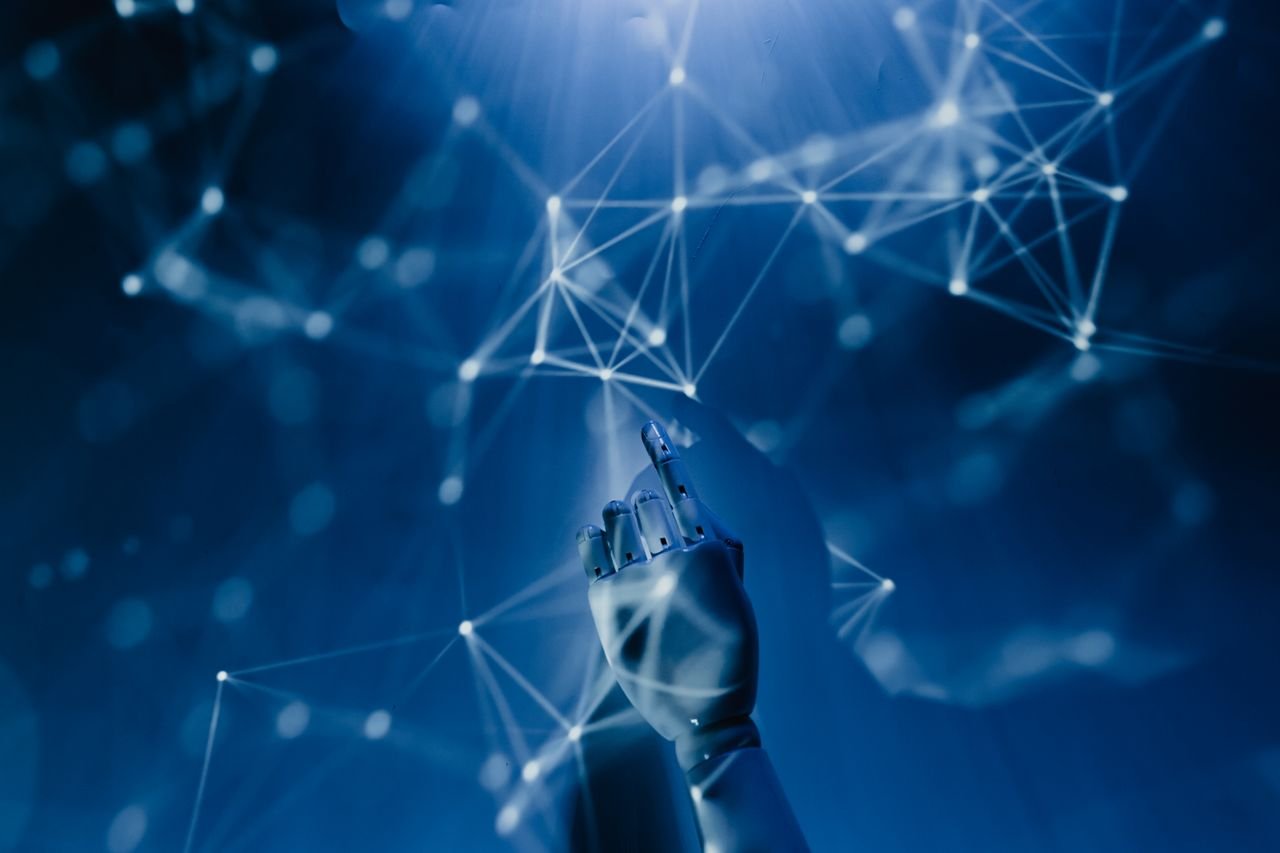 Mastering the First Impression: Your intriguing post title goes here A robotic hand reaching into a digital network on a blue background, symbolizing AI technology.